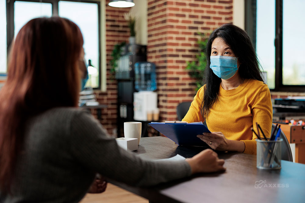 A staffing manager sits a table with a colleague