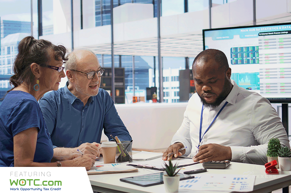 A diverse team collaborates on tax strategy, leveraging the WOTC Work Opportunity Tax Credit. Accountant helping senior clients maximize WOTC benefits. New tax credit program available."