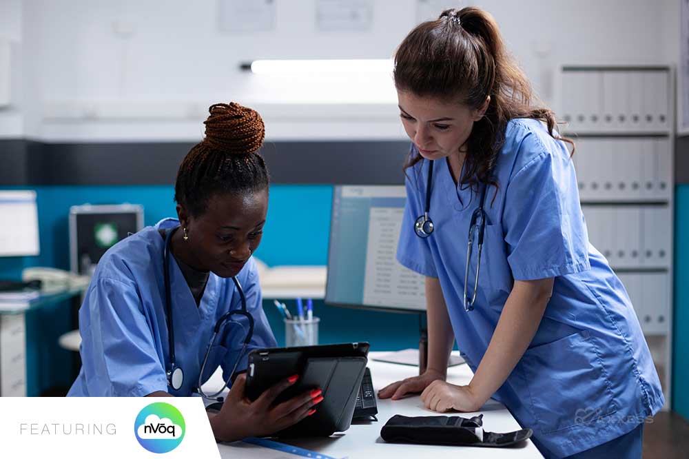 Considering the options, the second one strikes a good balance. Image of two nurses, one African-American and one Caucasian, in blue scrubs reviewing information on a tablet in a hospital or clinic setting. A &ldquo;New&rdquo; banner is in the corner and the image is labeled &ldquo;Featuring nVoq.&rdquo;