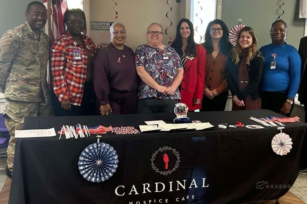 Cardinal Hospice Care team members gathered behind an information table during a community outreach event, highlighting hospice services and care support resources.